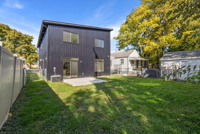 back of house featuring a patio area, a lawn, and cooling unit