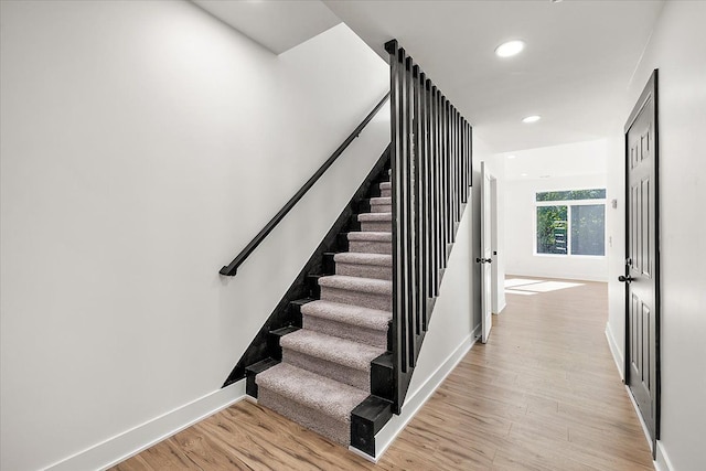 stairway featuring hardwood / wood-style floors