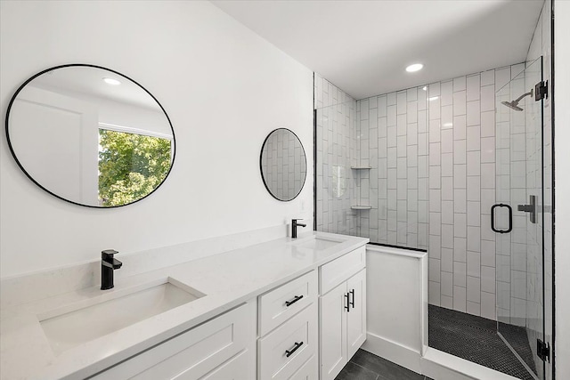 bathroom with tile patterned floors, a shower with door, and vanity