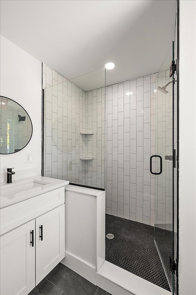 bathroom featuring vanity, walk in shower, and tile patterned flooring