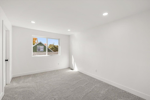 unfurnished room with light colored carpet