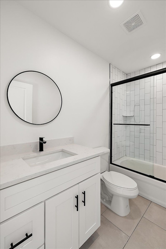 full bathroom featuring vanity, toilet, enclosed tub / shower combo, and tile patterned flooring