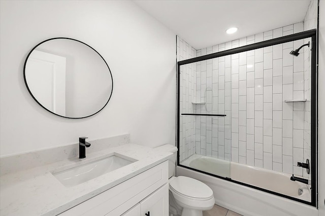 full bathroom featuring tile patterned floors, bath / shower combo with glass door, toilet, and vanity