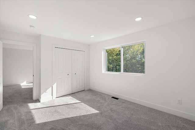 unfurnished bedroom featuring a closet and carpet flooring