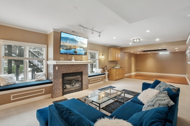372 Overlook Dr, Oxford, MI 48371 - living room with a tile fireplace, a wealth of natural light, crown molding, and baseboards