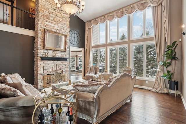 372 Overlook Dr, Oxford, MI 48371 - living area with baseboards, a chandelier, high vaulted ceiling, hardwood / wood-style flooring, and a fireplace