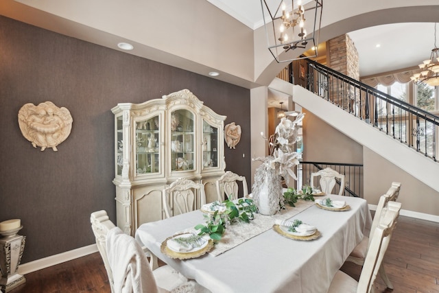 372 Overlook Dr, Oxford, MI 48371 - dining room with arched walkways, baseboards, a notable chandelier, a high ceiling, and hardwood / wood-style floors