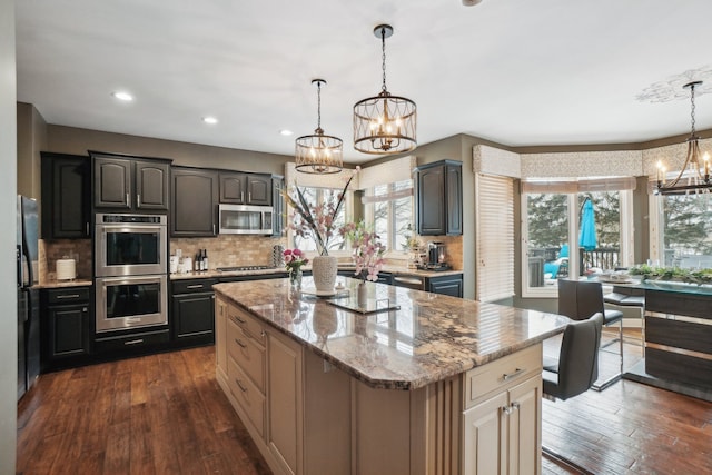 372 Overlook Dr, Oxford, MI 48371 - kitchen with an inviting chandelier, a center island, stainless steel appliances, and dark wood-style floors