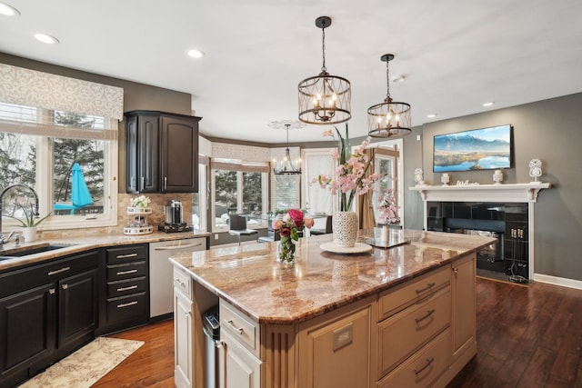 372 Overlook Dr, Oxford, MI 48371 - kitchen with dark wood finished floors, light stone counters, dishwasher, a sink, and a notable chandelier