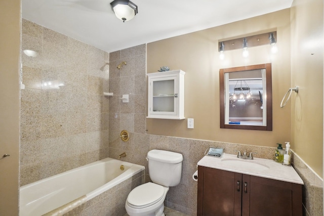 372 Overlook Dr, Oxford, MI 48371 - bathroom featuring tile walls, vanity, tiled shower / bath, and toilet