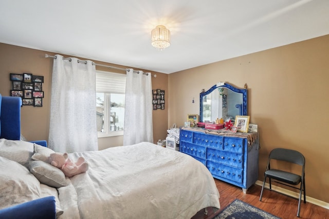 372 Overlook Dr, Oxford, MI 48371 - bedroom with wood finished floors, baseboards, and a notable chandelier