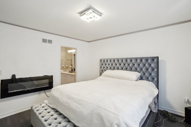 372 Overlook Dr, Oxford, MI 48371 - bedroom with wood finished floors, ensuite bathroom, an inviting chandelier, ornamental molding, and visible vents