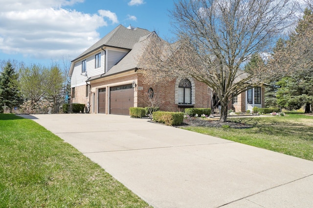 372 Overlook Dr, Oxford, MI 48371 - view of front facade with an attached garage, concrete driveway, a front yard, and brick siding