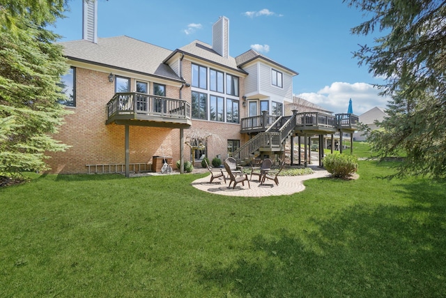 372 Overlook Dr, Oxford, MI 48371 - rear view of house with stairway, a patio area, a chimney, a lawn, and a wooden deck