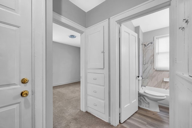 bathroom with bathtub / shower combination and toilet