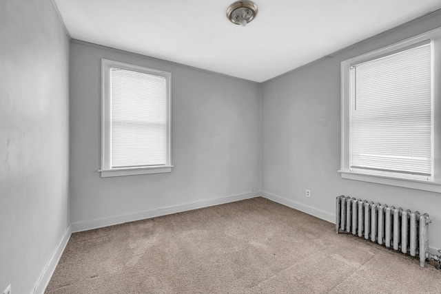 carpeted empty room with radiator