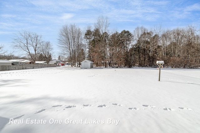 snowy yard with a shed