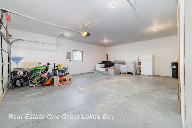 garage featuring electric panel and white fridge