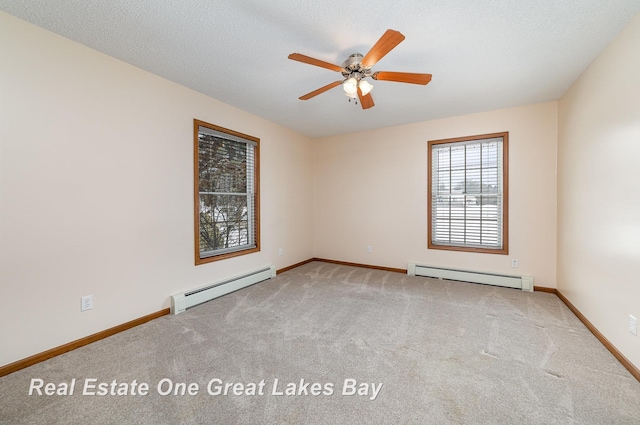 carpeted spare room featuring a baseboard radiator, a textured ceiling, and ceiling fan