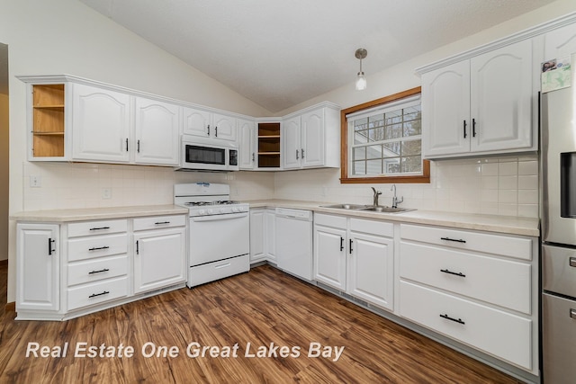 kitchen featuring sink, white appliances, and white cabinets