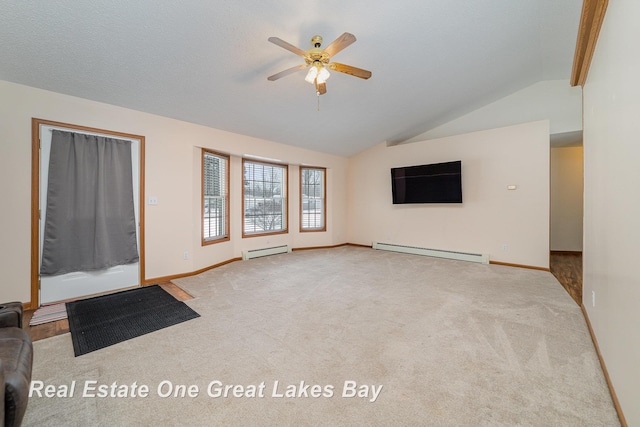 unfurnished living room with light carpet, baseboard heating, vaulted ceiling, and ceiling fan