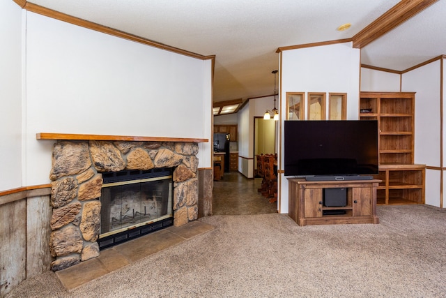 carpeted living room featuring vaulted ceiling, ornamental molding, and a stone fireplace