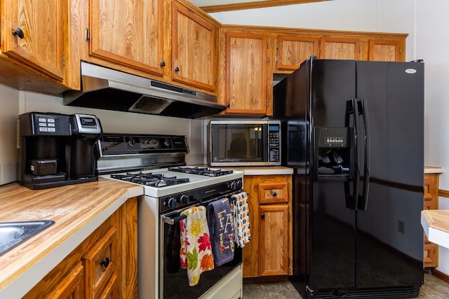 kitchen featuring sink, white gas stove, and black refrigerator with ice dispenser