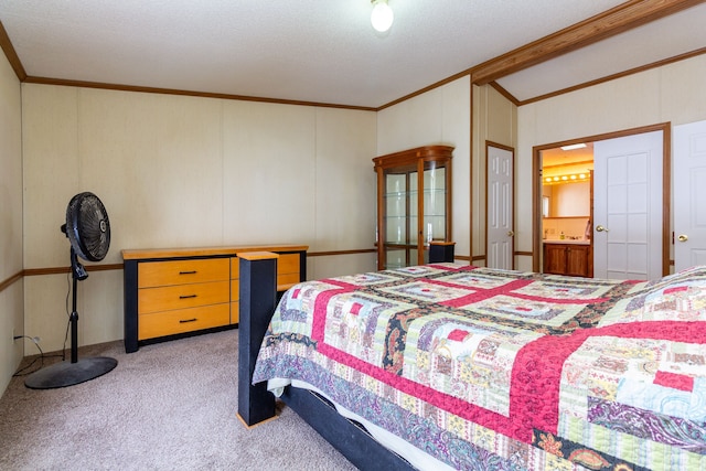 bedroom featuring ensuite bath, carpet floors, and ornamental molding