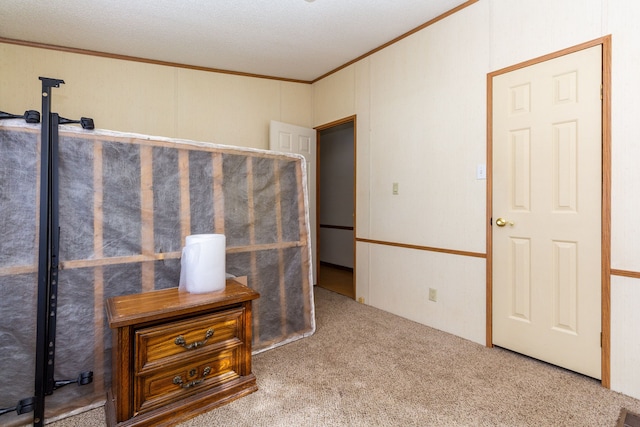 interior space with crown molding and carpet flooring