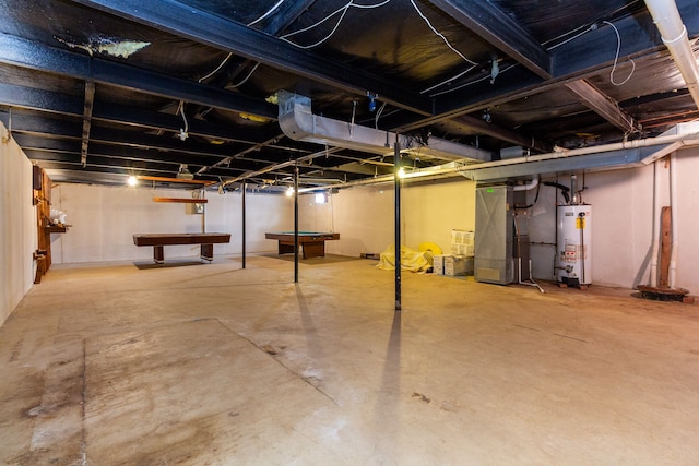 basement featuring heating unit, pool table, and water heater