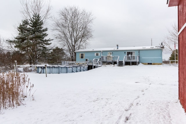 snow covered property featuring a swimming pool side deck