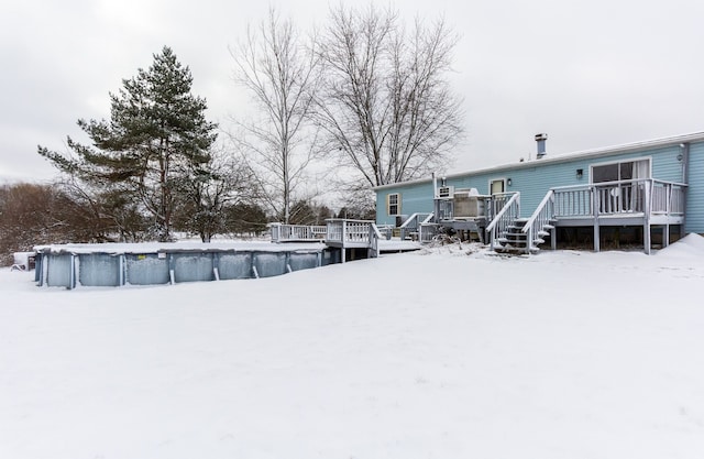 yard layered in snow featuring a pool side deck