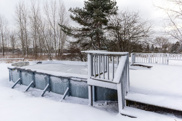 snow covered deck featuring a covered pool