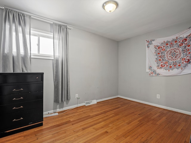 unfurnished bedroom featuring hardwood / wood-style flooring