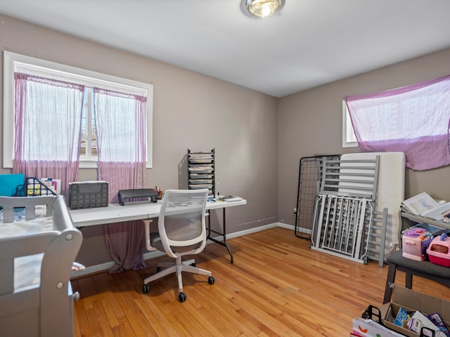 office area featuring plenty of natural light and light hardwood / wood-style flooring