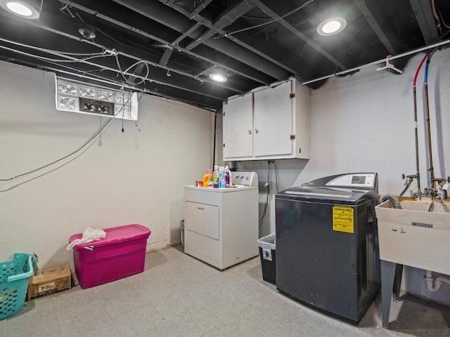 laundry area featuring cabinets, sink, and washing machine and clothes dryer