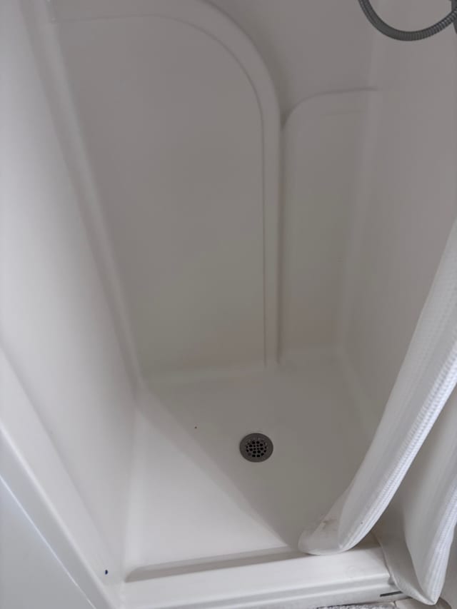 room details featuring a shower stall