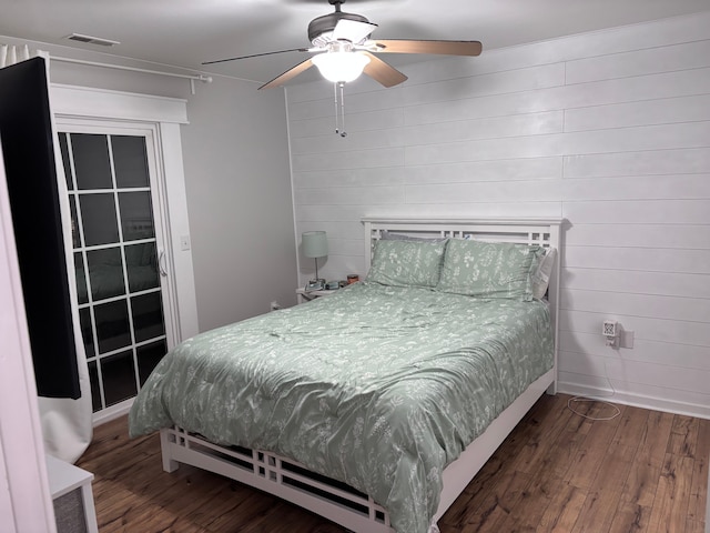 bedroom featuring baseboards, ceiling fan, visible vents, and dark wood-type flooring