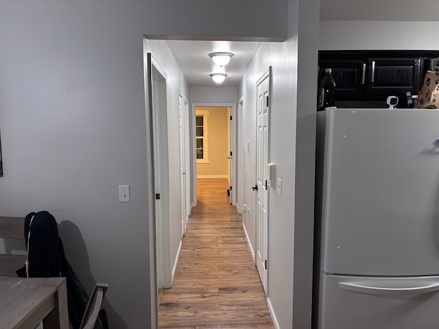 corridor with light wood finished floors