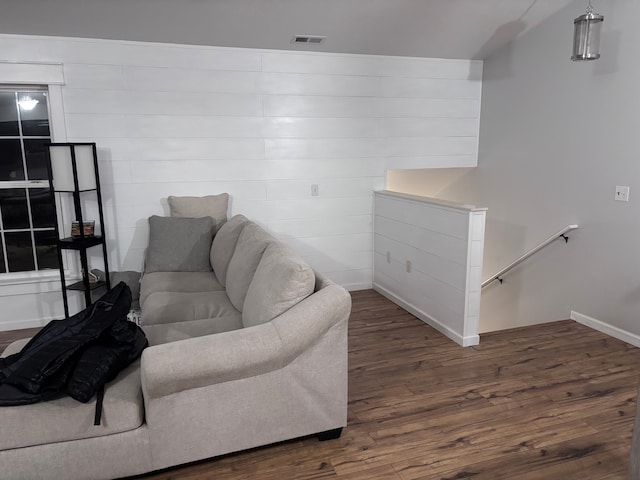 living room featuring baseboards, visible vents, and dark wood-type flooring