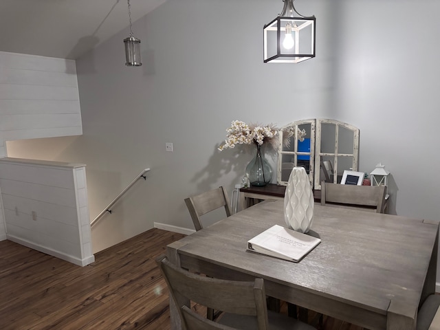 dining room featuring baseboards, vaulted ceiling, and dark wood-type flooring