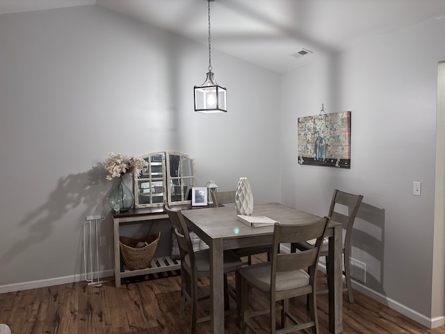 dining room featuring visible vents, dark wood finished floors, and baseboards