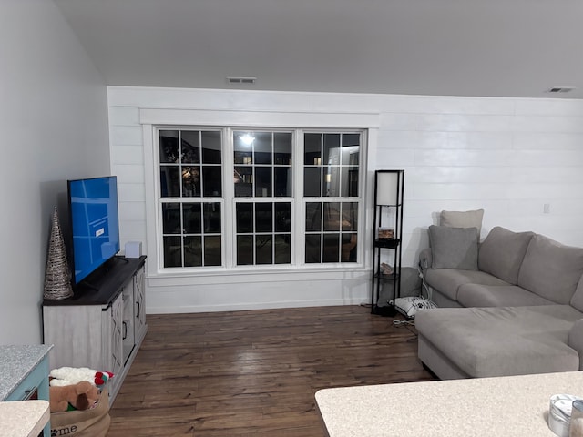 living room featuring dark wood-type flooring and visible vents