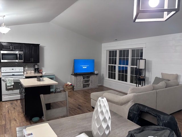 living room with vaulted ceiling and wood finished floors