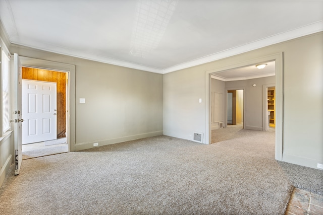 unfurnished room with light colored carpet and crown molding