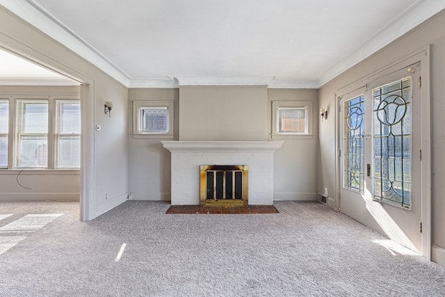 unfurnished living room featuring a brick fireplace, plenty of natural light, and crown molding