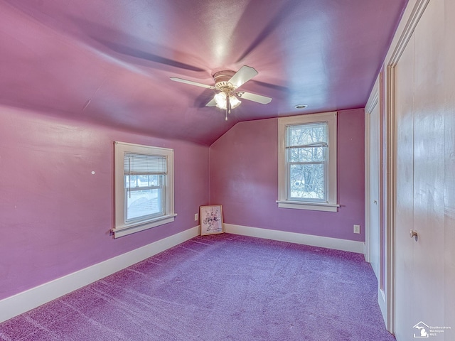 additional living space with lofted ceiling, light carpet, and plenty of natural light