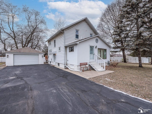 view of front of property with a garage and an outdoor structure