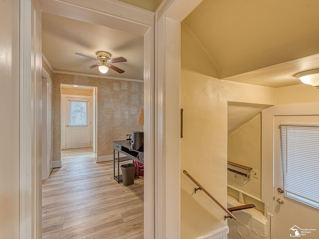 corridor featuring crown molding, lofted ceiling, and light hardwood / wood-style flooring