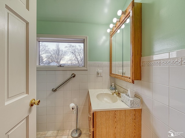 bathroom with vanity and tile walls